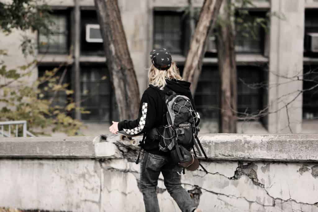 skateboard teen boy with long hair