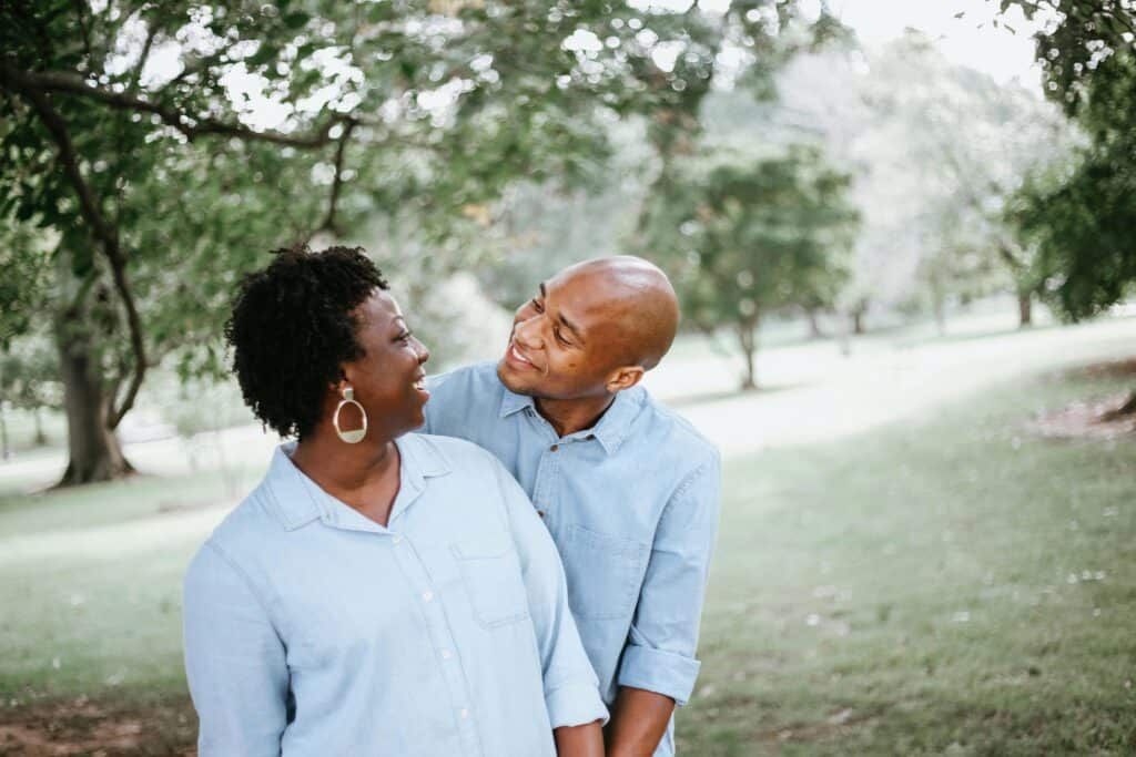 couple older outdoors smiling at each other